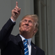 US President Donald Trump looks up at the partial solar eclipse from the balcony of the White House in Washington, DC, on August 21, 2017.